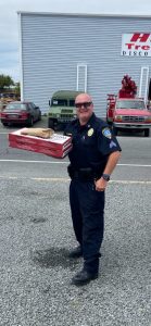 Sergeant Parsons bringing pizzas for the department
