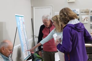 Town residents looking at municipal map